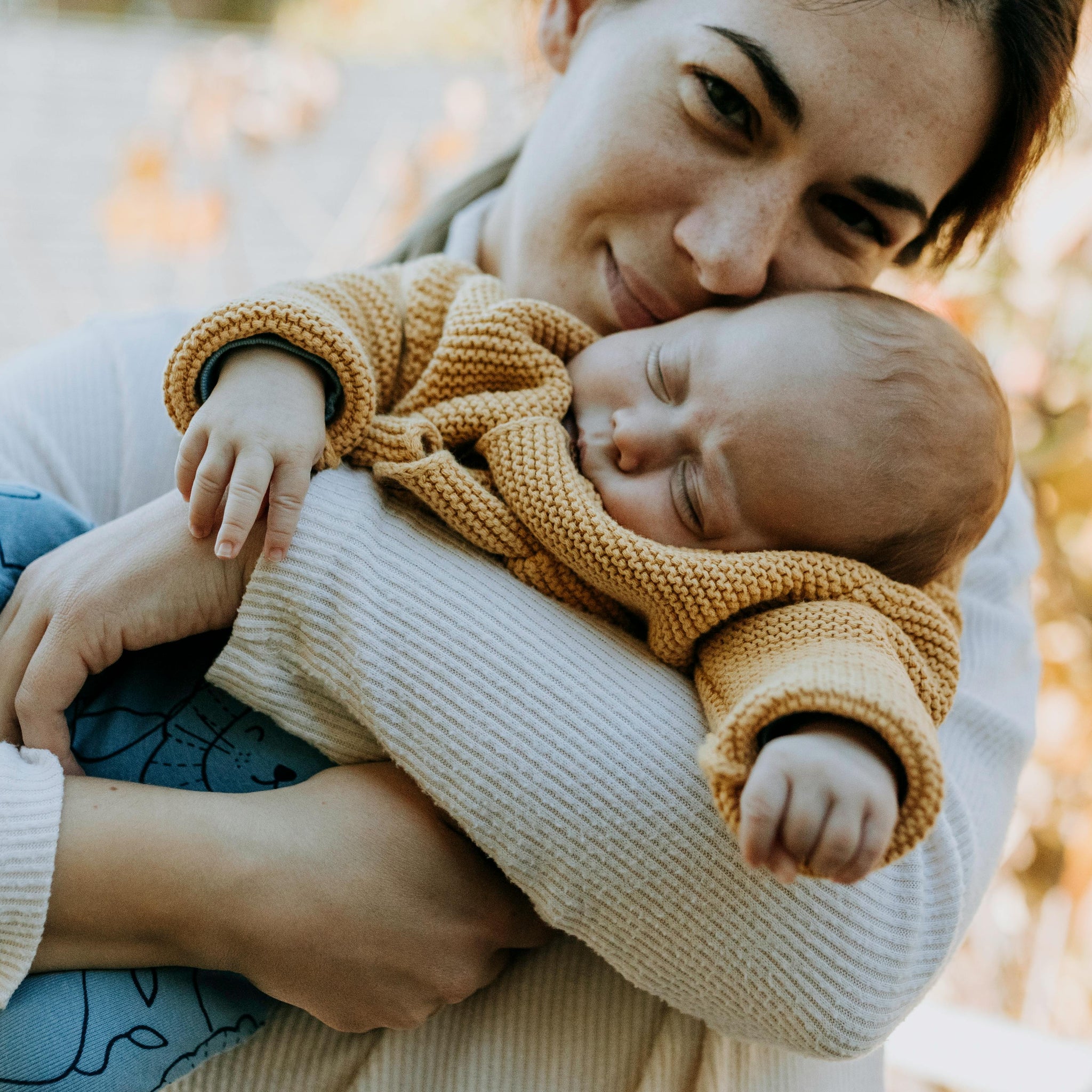 Woman holding baby wearing comfortable pyjamas