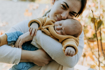 Woman holding baby wearing comfortable pyjamas